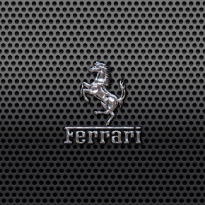 Ferrari Prancing Horse of Maranello logo on a black metal mesh wallpaper 1440x900 Ferrari Prancing Horse of Maranello logo on a black metal mesh wallpaper 1440x900